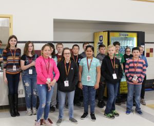 A group of a dozen students stands
