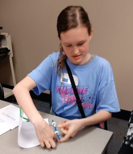 A girl works at a table