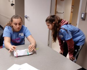 Two girls work at a table