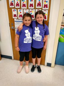 Two girls stand together