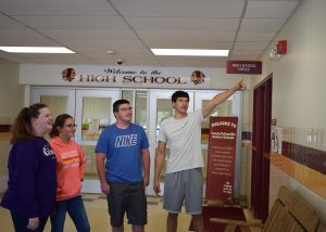 Four students stand in an entryway