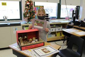 a shoebox diorama shows a model of a chicken coop