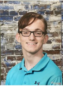 portrait of a high school student wearing a polo shirt and glasses