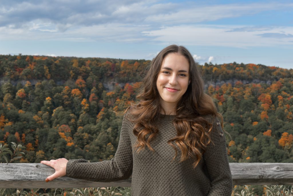 outdoor scenic portrait of a high school senior with long brown hair