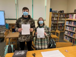 FFHS students posing with their final research papers.