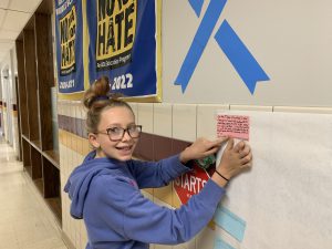 FFMS student sharing her 'Act of Kindness" note on the banner in the middle school.