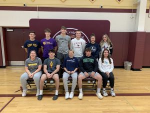 FFHS student-athletes posing for their group photo to recognize their next step into college athletics. Seated - left to right: Emma Crahan, Owen Hicks, Elinor Slezak, Jonathan Cranker and  Maddy Mott. Standing - left to right: Logan Yaggle, Jackson Croucher, Brady Whipple, Jackson Cusack, Talor Ferrucci and Amelia Petersen. Not in pictured: Talia Anderson, Bennett Melita Amber Cole and Jeremiah Jimenez.