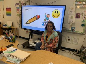 Ms. Ortiz preparing for the arrival of her students in her classroom.