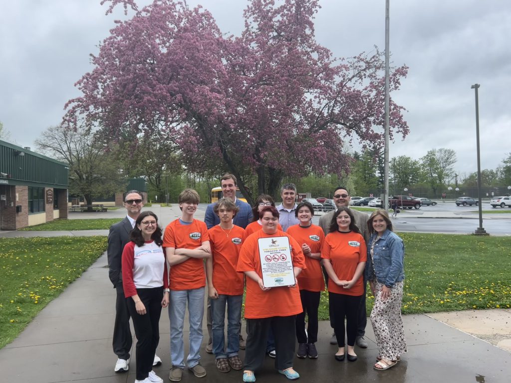 The picture features FFCS administration members (back row from left to right), Aaron Grady (HS Principal), Kyle Roberts (Assistant Principal), Eric Romano (Elementary Principal), Dr. Richard DeMallie (District Supt.) and Health Education Teacher Ms. Gabel (Health Education Teacher) along with our Reality Check advisors and student members.
