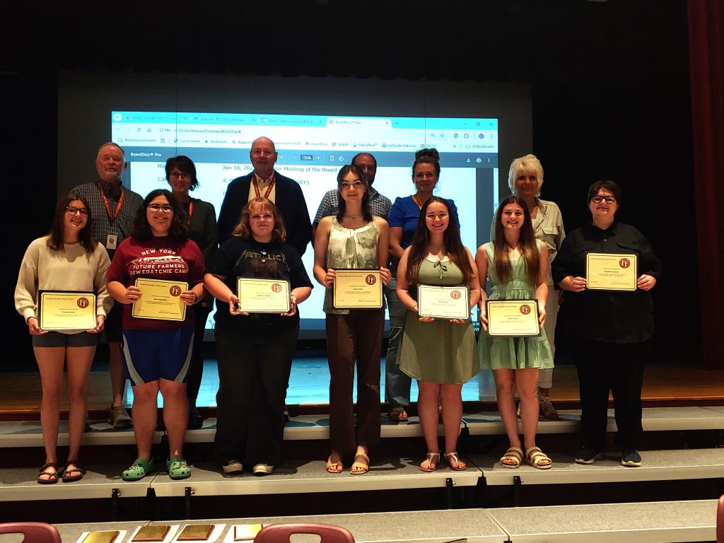 The Board of Education celebrated the achievements of the district's Class of 2025 Top 10 students. From left to right (bottom row): Theresa Stewart, Keira Muselbeck, Cassandra Denton, Ashley Glode, Allison Gillis, Rhyan Lewis and Elizabeth Vosburgh. The following Top 10 students were unable to attend: Colton Dowgielewicz, Preston Phillips, and Jake Hernigle. Board of Education members (back row, left to right) Dennis Egleston, Michelle Isabella, Matt Sullivan, Adam Sullivan, Jessica Munson and Bonnie Couture.